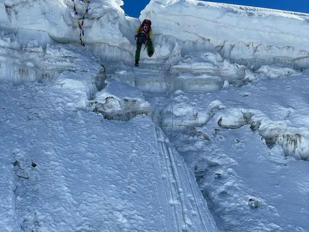 Climber ascending an icy section near the summit of Lobuche Peak in the Everest region, Nepal