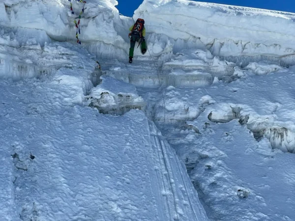 Climber ascending an icy section near the summit of Lobuche Peak in the Everest region, Nepal
