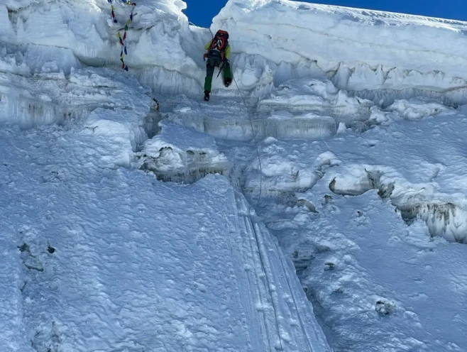 Climber ascending an icy section near the summit of Lobuche Peak in the Everest region, Nepal