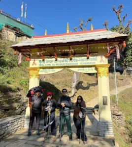 Four Himalayan trekkers are preparing for trekking at the Ghandruk trekking gate.