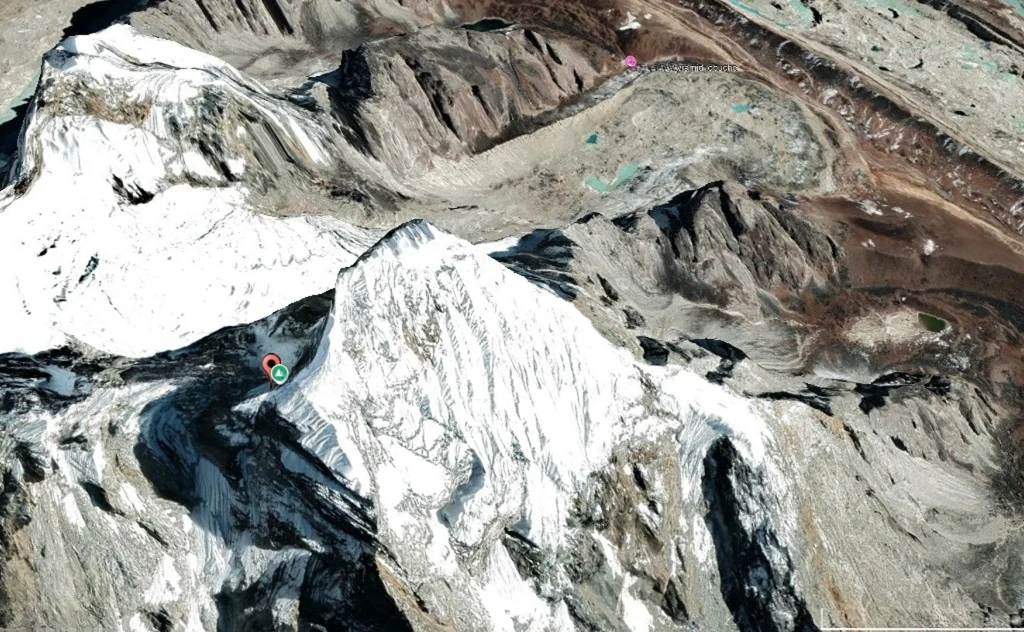 2D satellite view of Lobuche Peak showing snow-covered ridges and steep rocky slopes, with the nearby settlement of Lobuche visible in the rugged Himalayan landscape.
