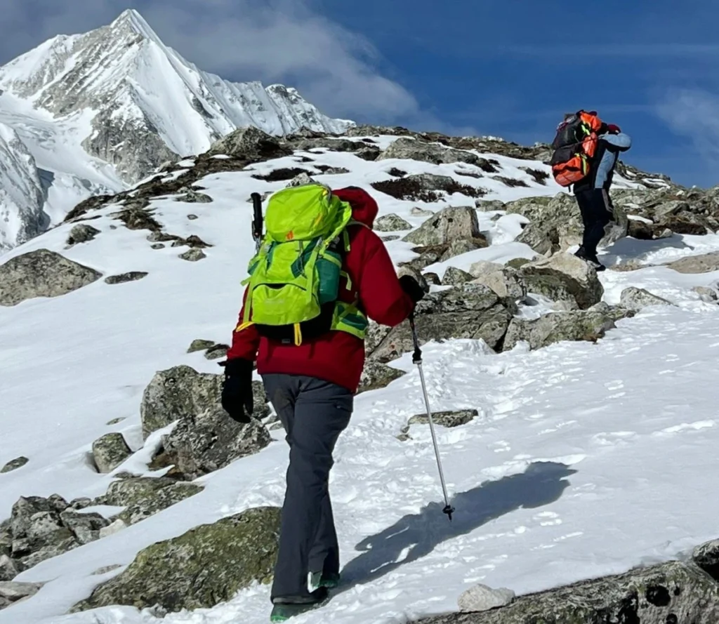 Manaslu Circuit Trek vs Everest Base Camp Trek - Complete 2026 Guide 4 Manaslu Circuit Trek vs Everest Base Camp Trek: Two trekkers hiking in the Manaslu region under snowy mountains