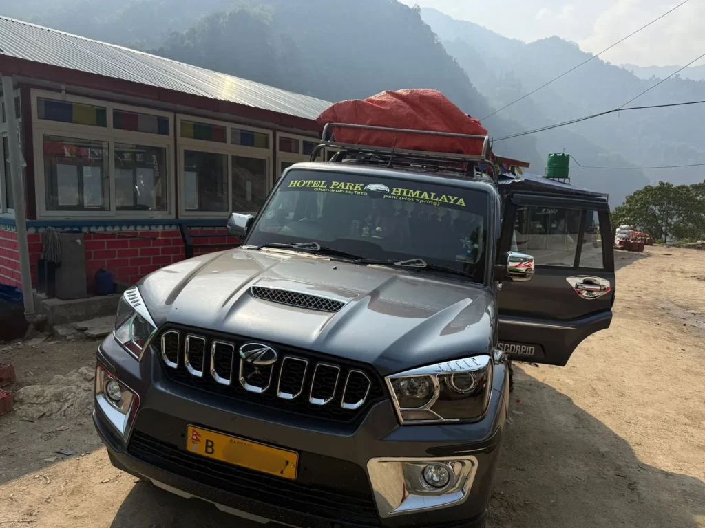 Annapurna Base Camp Trek Cost: Complete 2026 Guide 9 Tourist vehicle parked near lodge during Annapurna Base Camp journey in Nepal