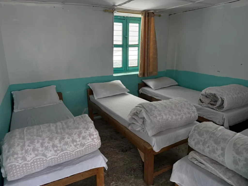 Accommodation During the Annapurna Base Camp Trek: Basic lodge room with four beds in Annapurna trekking region