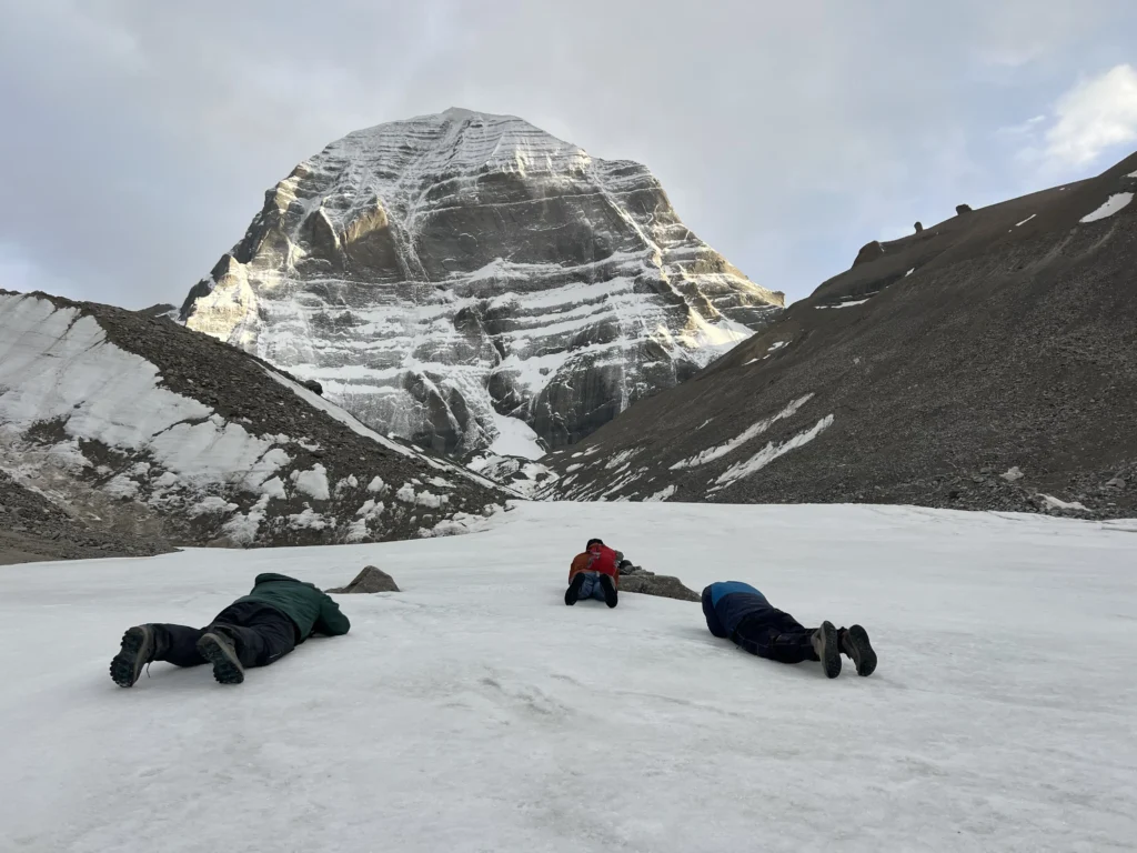 Pilgrims offering full-body prostration (Natamastak) in devotion at Mount Kailash.