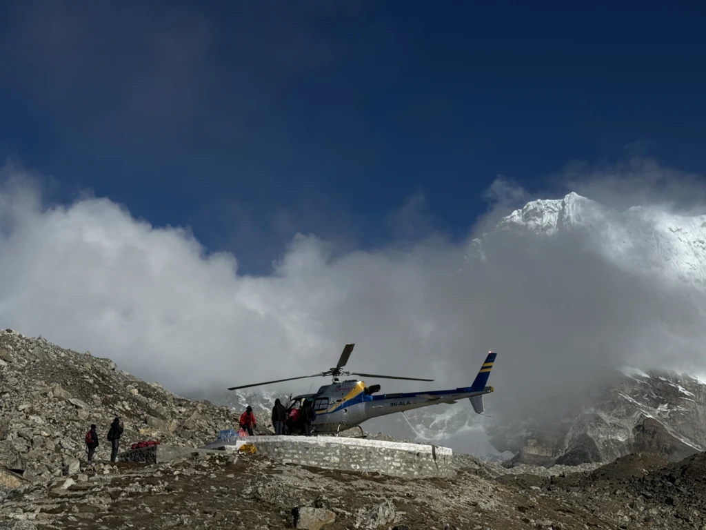 Helicopter landing at Everest Base Camp helipad.